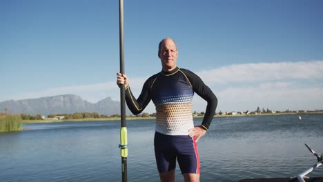 portrait of senior caucasian man standing by a river