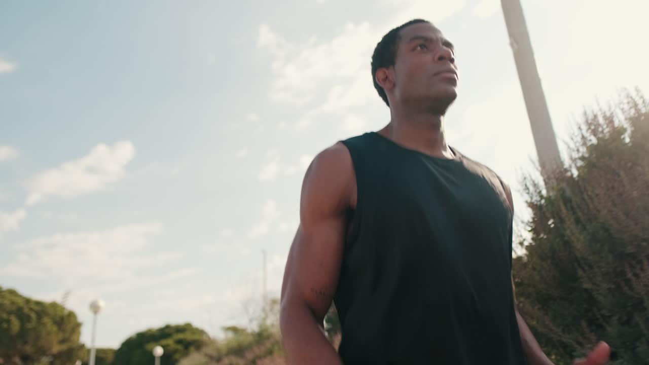 Young Man Jogging in a Park