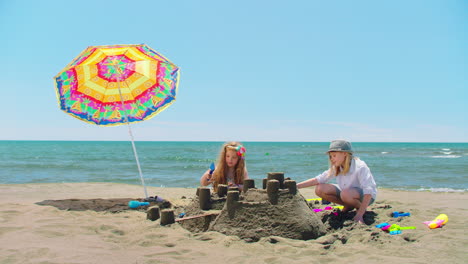 kids building sandcastles on the beach