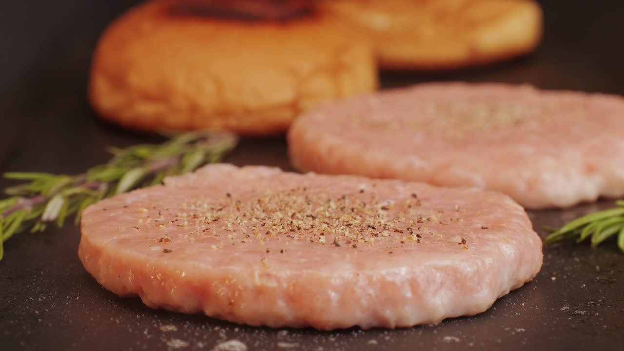 Cooking American fat smash burger on grill close-up. Chiken or fish cutlet smashing by burger press. The chef in kitchen of the restaurant making cutlets for burgers - smash burger beefsteak. Fast and street food concept. High quality 4k footage