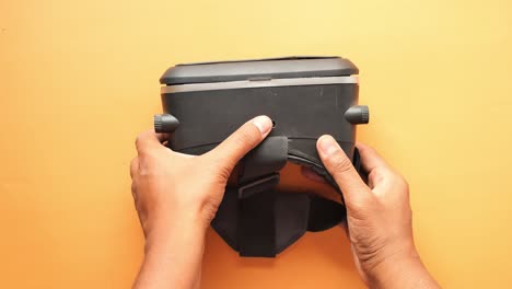 hands holding a black vr headset