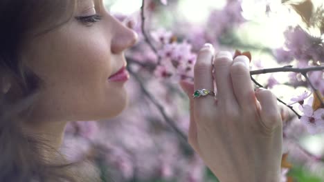 girl romantically sniffing spring flowers