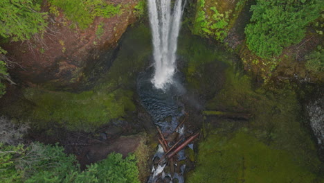 aerial view of a majestic waterfall in a lush forest