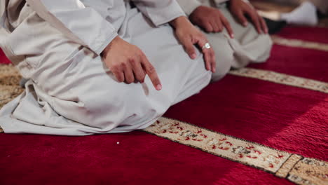 muslim prayer on carpet in mosque