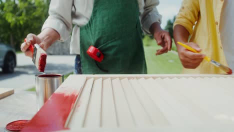 couple painting a wooden door