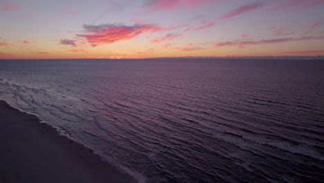 Aerial-Drone-Orange-Sunset-Skies-Over-Beach-Of