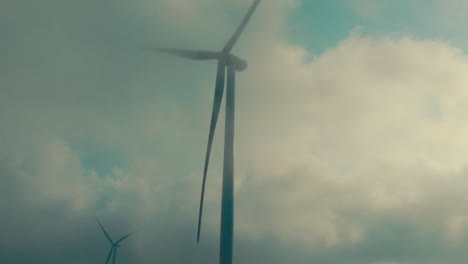 wind turbines in a misty sky