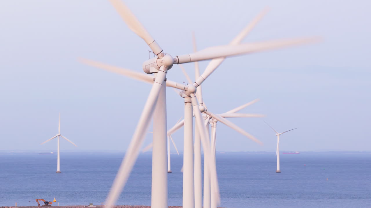 Aerial drone view of offshore wind turbines spinning in the sea at the Oresund Wind Farm in Copenhagen, Denmark