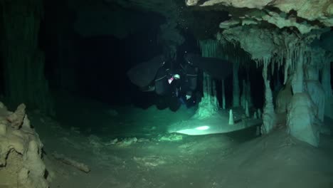 cave diver in a large decorated passage