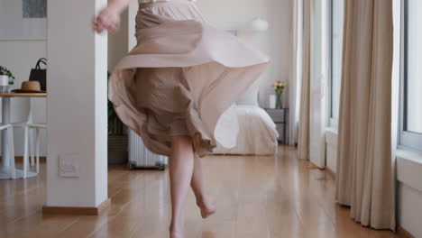 beautiful travel woman dancing in hotel room having fun celebrating summer vacation enjoying carefree holiday lifestyle