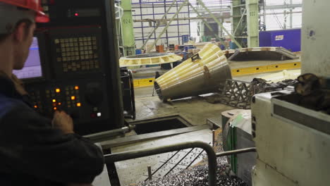 cnc machinist operating machine in a factory