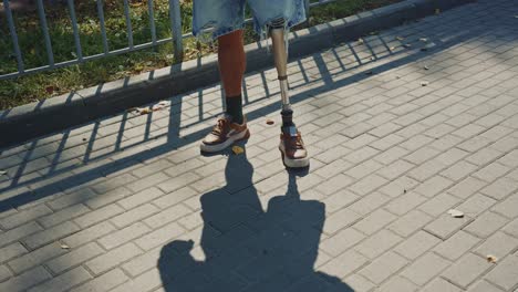 person with prosthetic legs on a sidewalk