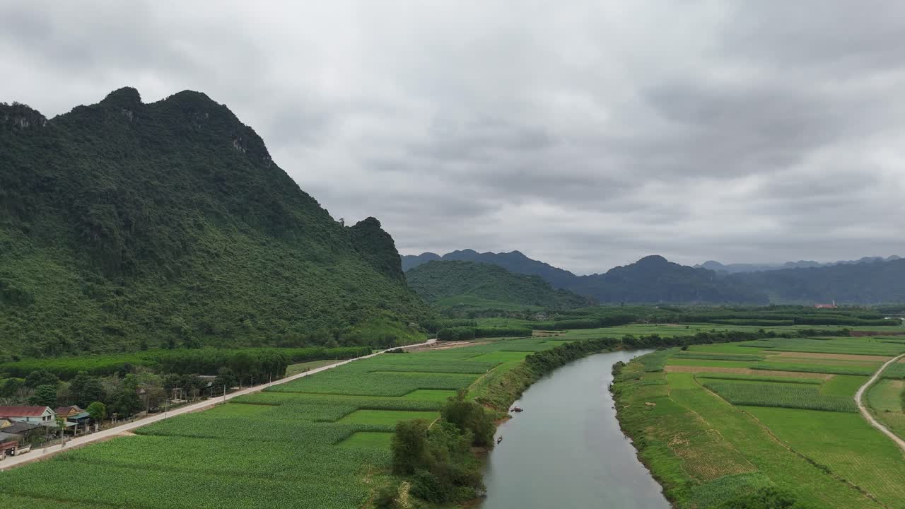 Beautiful Breathtaking Shot of River Passing Through Crop Fields with Rain Clouds in Sky