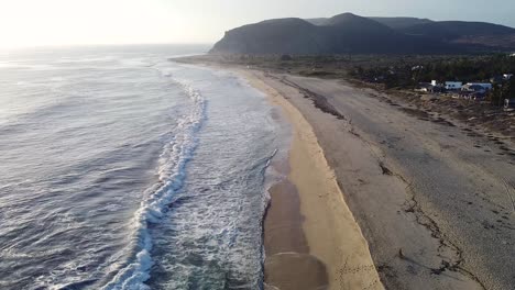 baja california sur mexican beach with waves breaking on pacific ocean shoreline during sunset