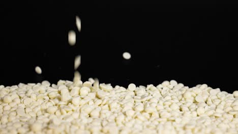 white chocolate chips cascading onto a pile