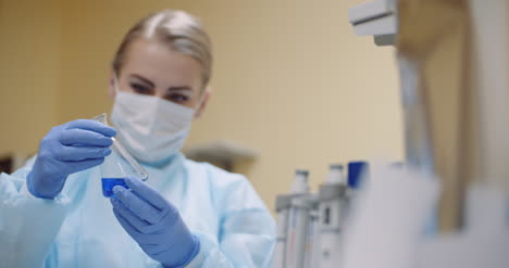 Scientist-Mixing-Liquid-At-Laboratory-4