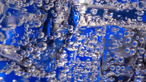 glass of water with ice on a dark blue background