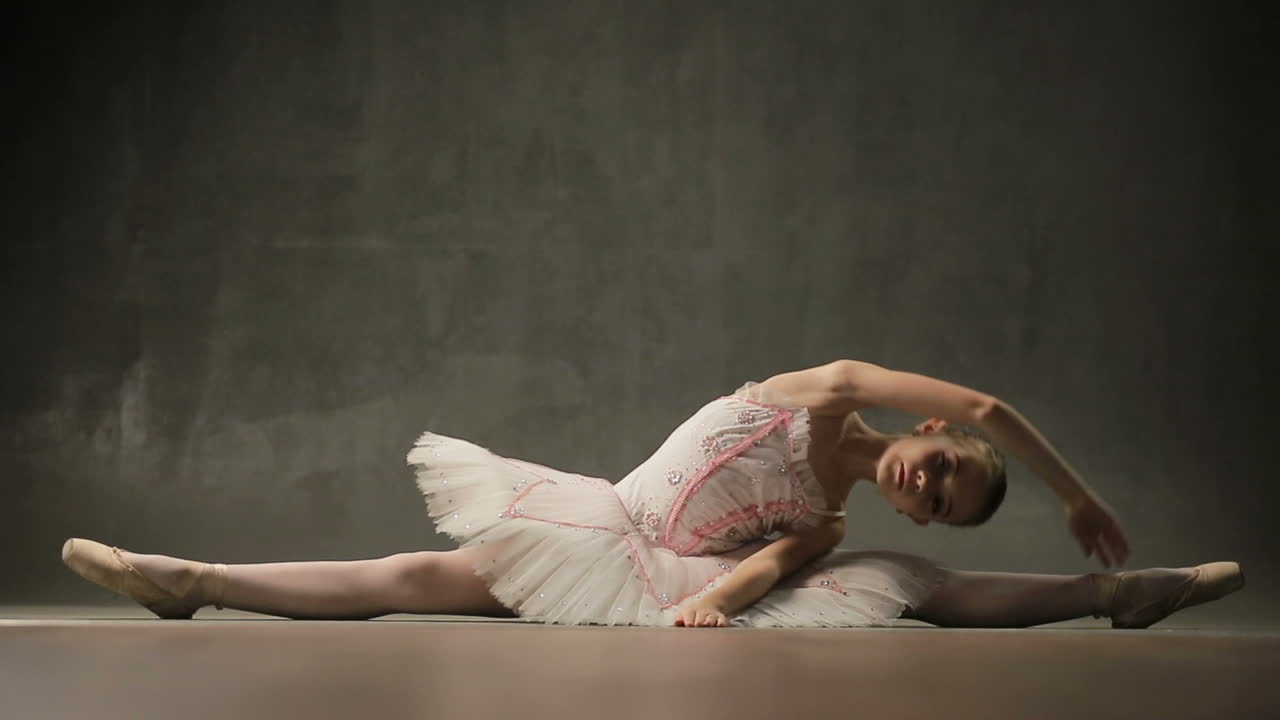 Ballerina In Ballet Studio. Young ballerina standing on poite in ballet studio