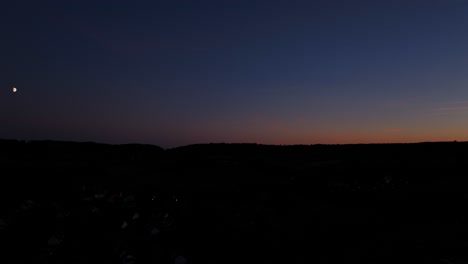 In-distance-the-first-signs-of-orange-sunlight-breaking-over-ground