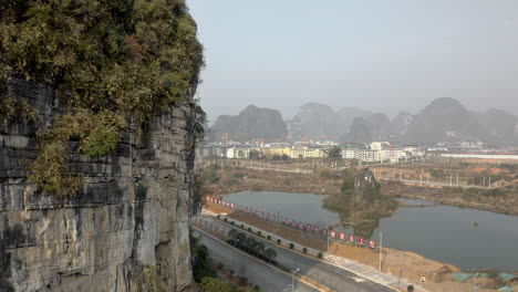 action shot of female rock climber on mountain rock face, chinese city backdrop