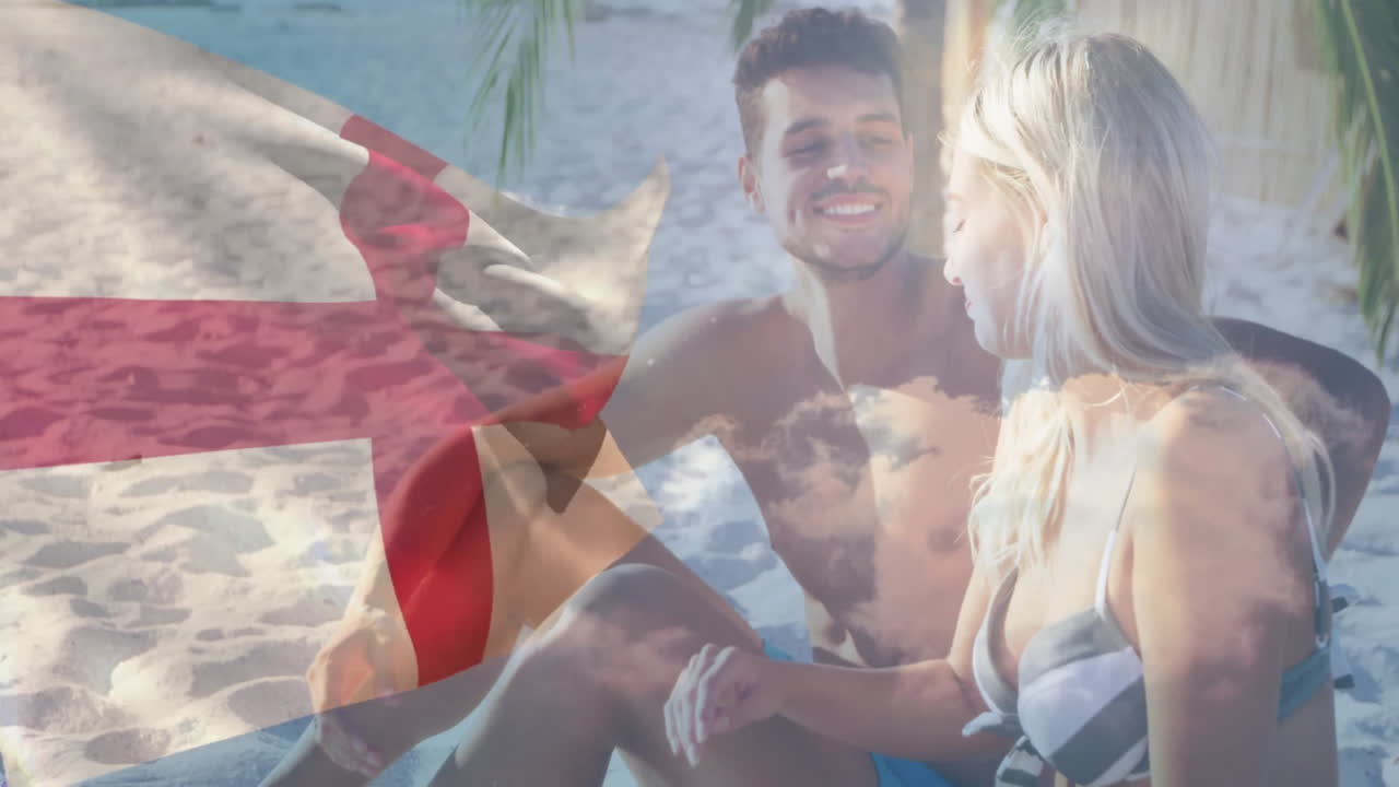 Relaxing on beach, couple with England flag overlay in animation scene