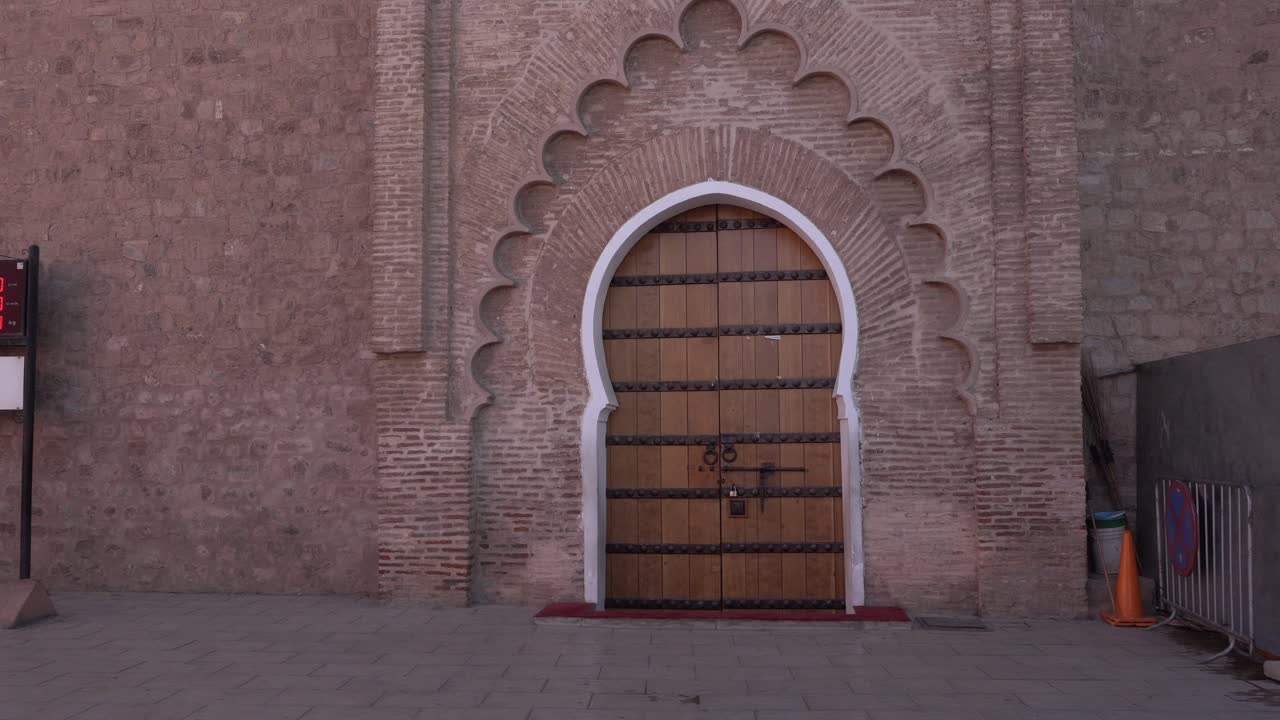 A Moroccan door that is truly beautiful because of its patterns. The whole thing is set on a brick wall