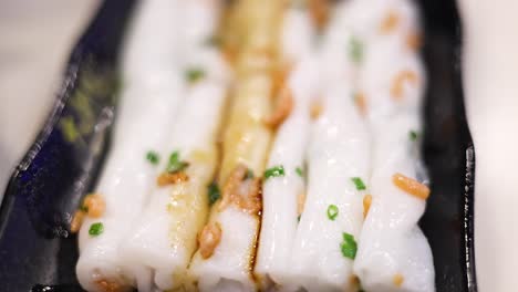 close-up of rice noodle rolls being prepared