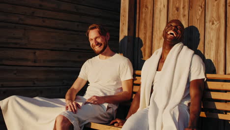 two happy men laughing and relaxing in a spa or sauna