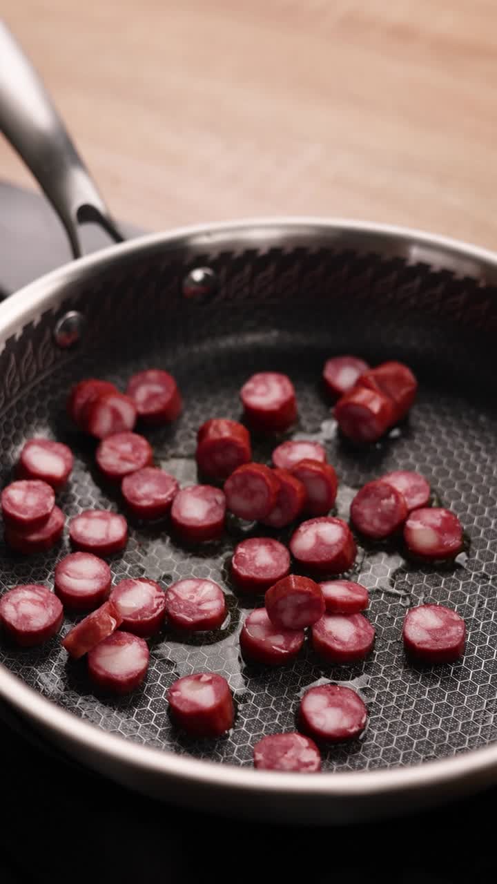 Cooking Sliced Sausages with Onions in a Pan