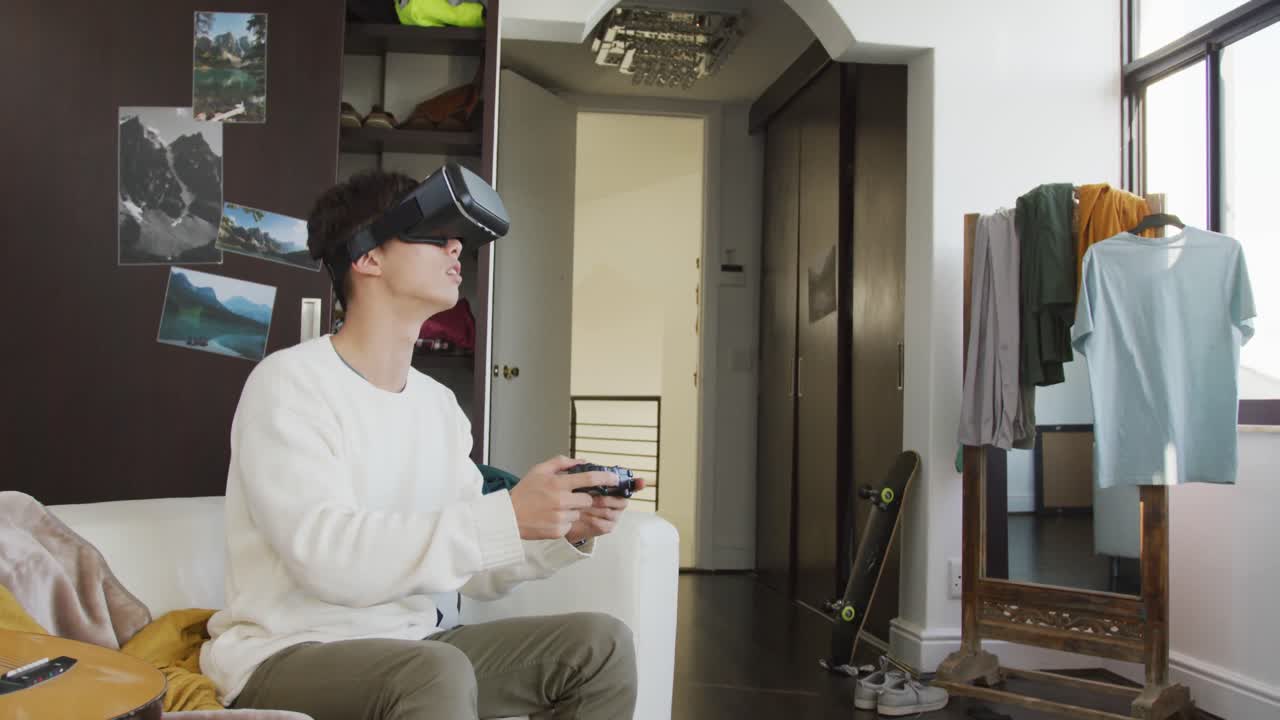 Asian boy wearing vr headset playing video games at home