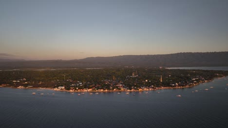 aerial view of a coastal town with boats at sunset