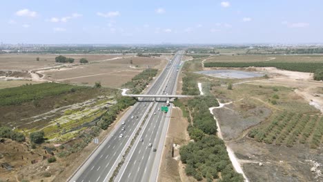 highway-runs-through-agricultural-fields,-A-sunny-summer-day-and-blue-sky