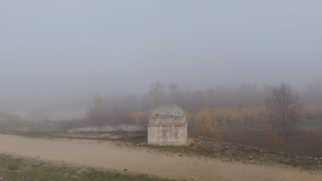 Rotating-aerial-over-the-lonely-and-isolated-concrete-bunker,-built-near-of-The-Barrage-du-Planas,-a-dam-located-in-Avignon,-France