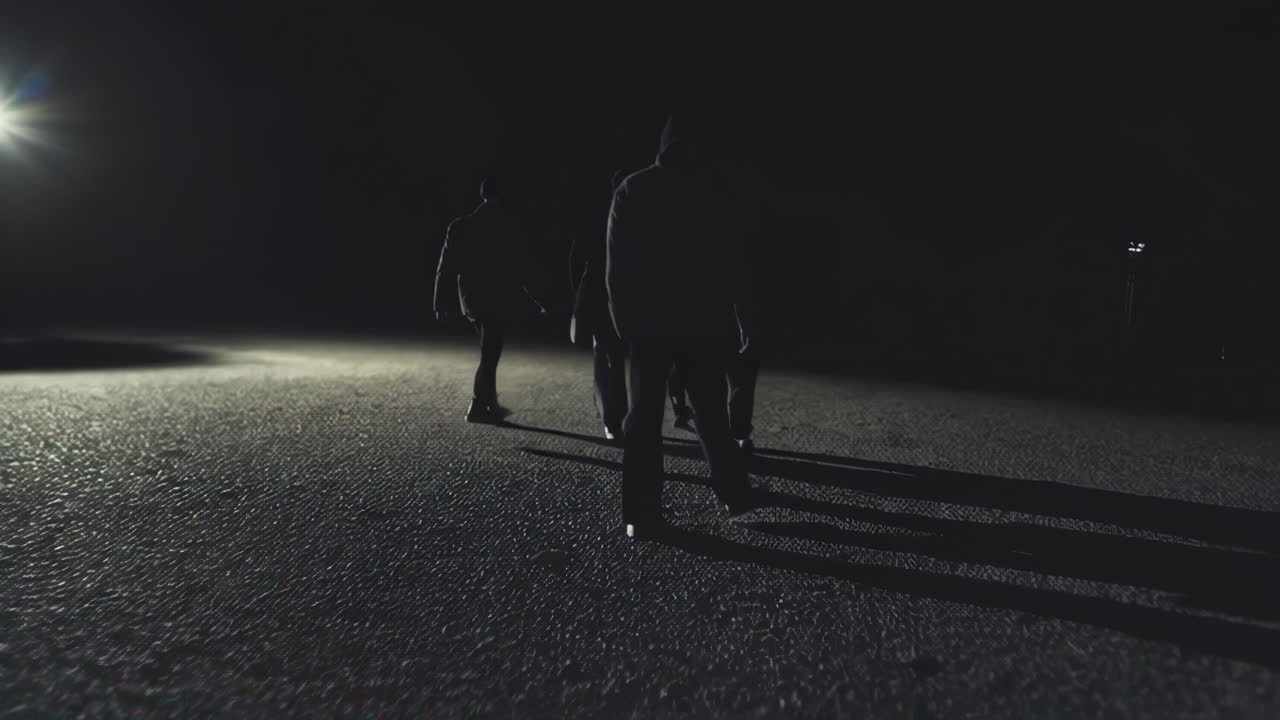 People Walking at Night on Ice