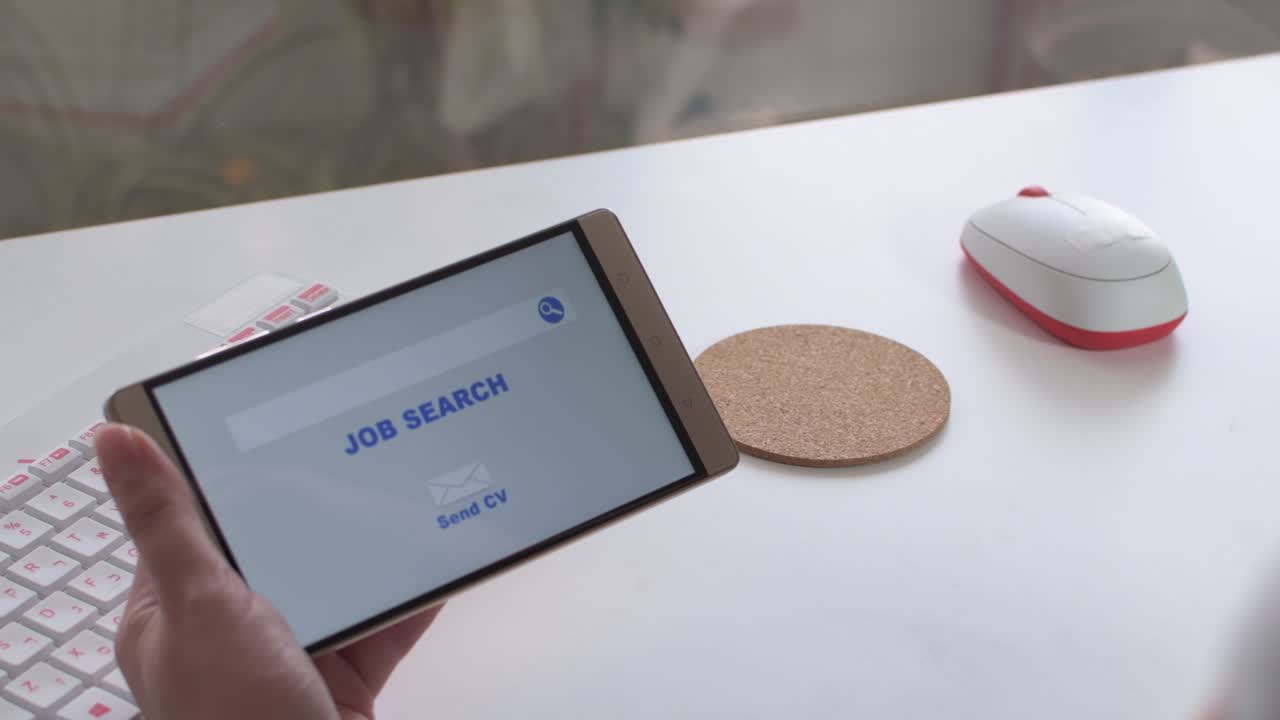 Online job search, woman's hands holding a mobile in which an employment website appears, and drinking coffee.