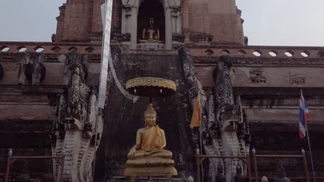 a rising reveal shot of the entrance to the wat chedi luang, also known as the jedi luang and â€œthe temple of the great stupaâ€ in thailand