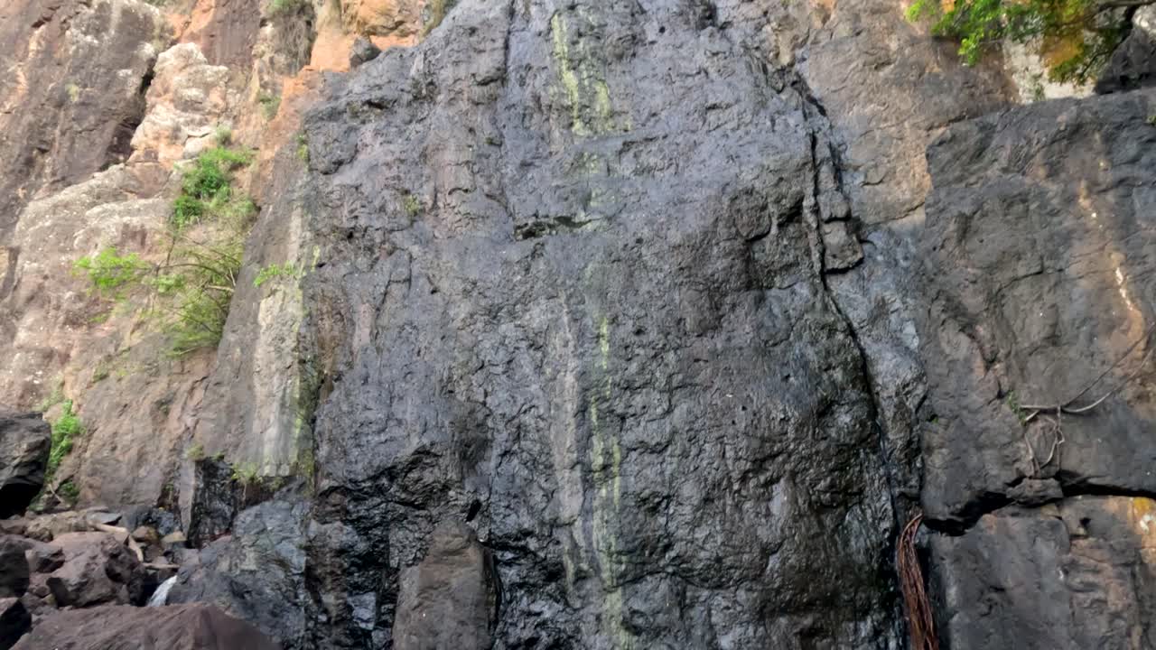 una cascada que cae en cascada por un acantilado rocoso