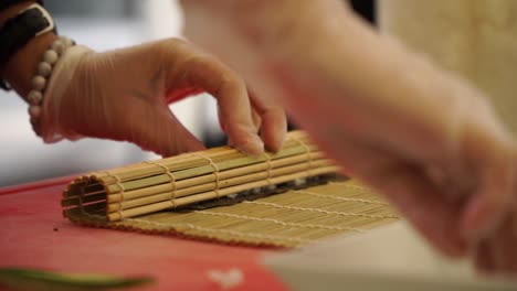 slowmo - japanese chef preparing sushi rolls