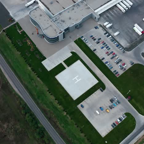 industry near the road. parking zone with cars and trucks on the industrial territory on field. top aerial view.