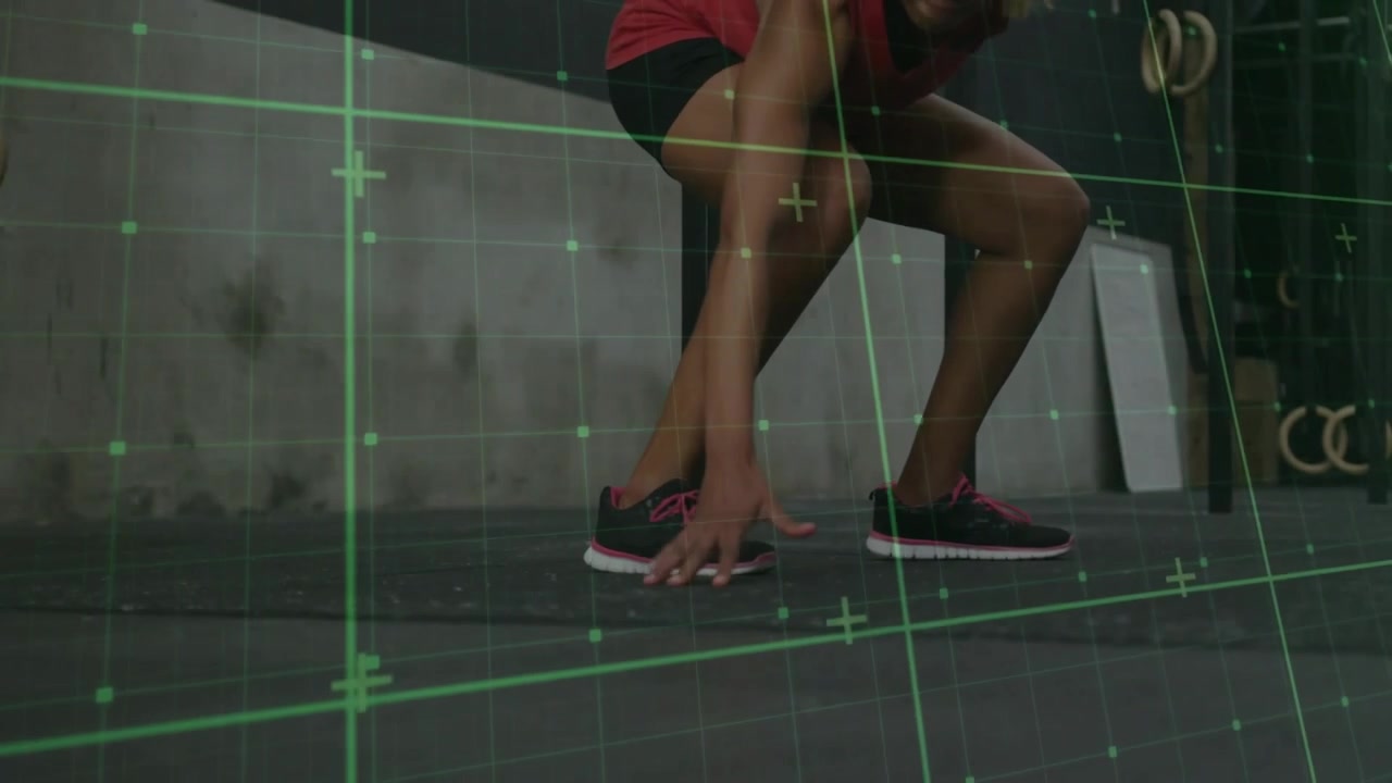 Woman stepping forward and lowering into side lunge, green grid tracking footwork for exercise