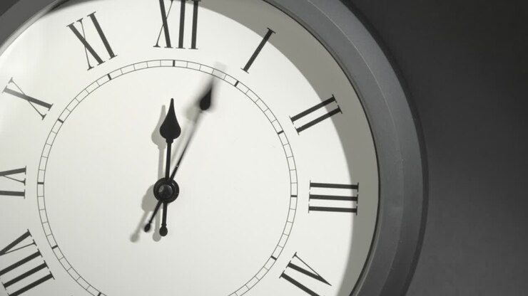 Latin Clock Face in Time Lapse on Dark Grey Wall