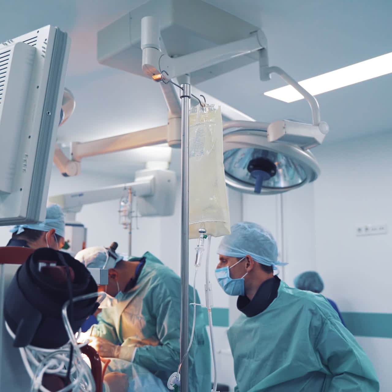 Many modern equipment in the operating room. Operation process on the background of medical furnishing in private clinic. Monitors and other accessories for surgeons in hospital inside.
