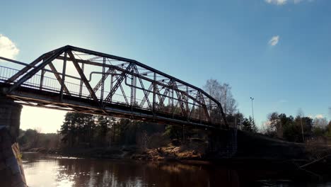 bright sun shining through the dzelzitis ainazi-smiltene bridge of the former narrow-gauge railway in valmiera, latvia