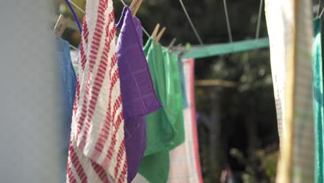 Colored-Face-Towels-Hanging-On-Clothesline-Drying-In-The-Sun-Outdoor