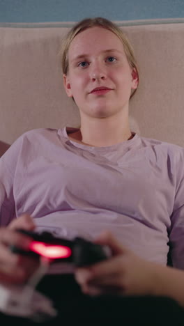 teenage girl playing video games on a couch