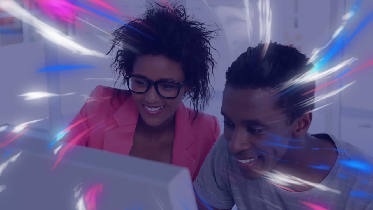 Animation of digital waves over african american male and female colleagues using computer at office