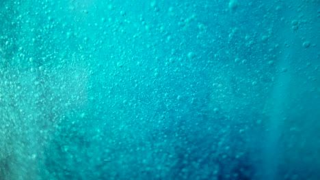 fondo azul de bucle sin fisuras, pequeñas burbujas suben lentamente a través del líquido