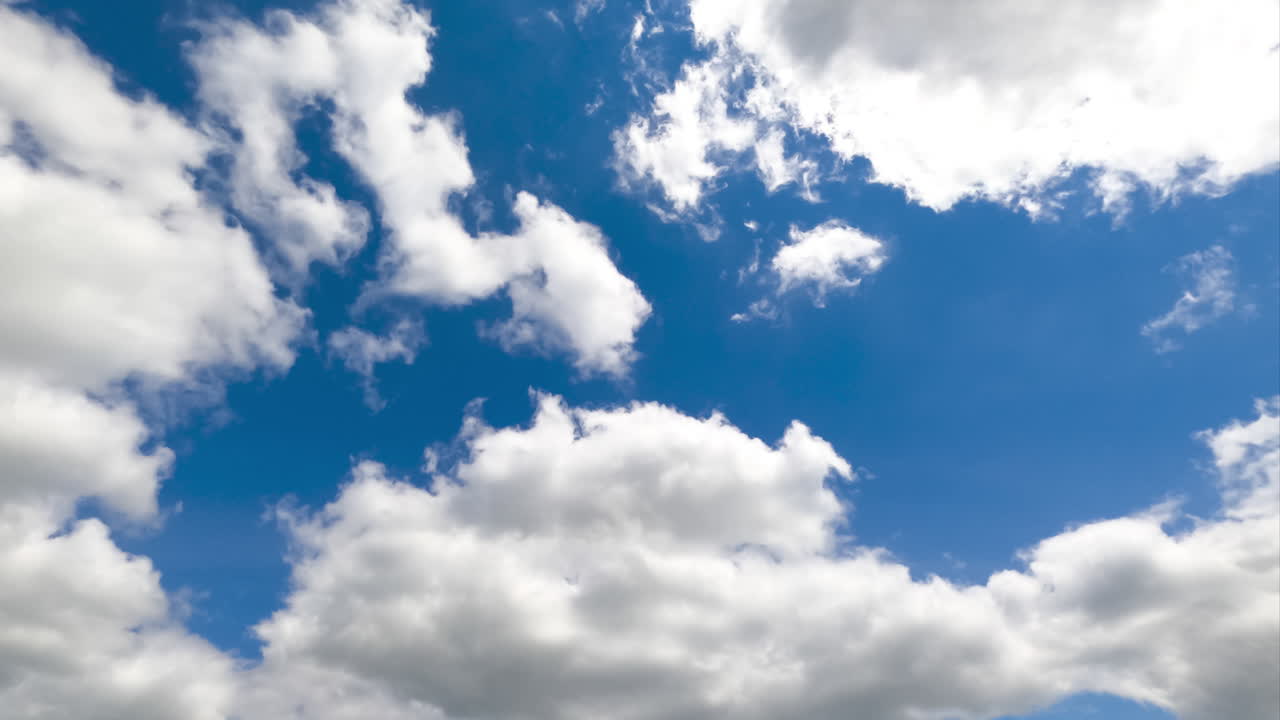 Soft white clouds transforming in the sky. Beautiful fluffy clouds flying quickly timelapse.