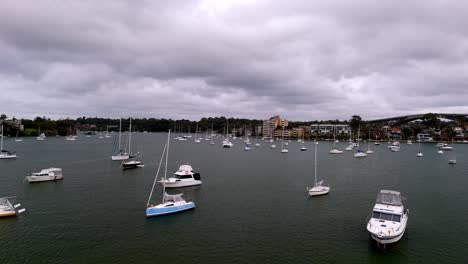 serenity on the water: a calm marina filled with boats against a cloudy sky backdrop