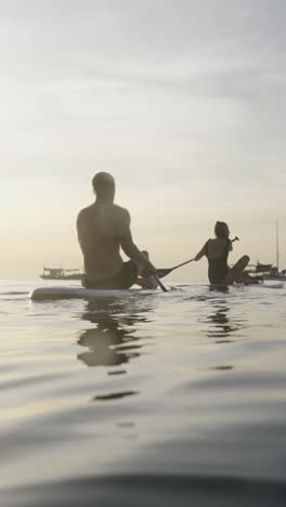 man paddleboarding at sunset